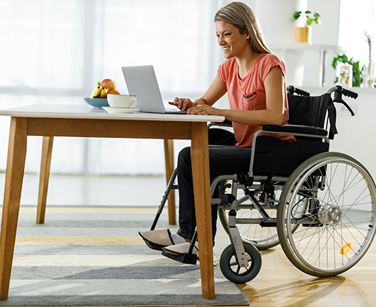 woman in wheelchair working on laptop computer