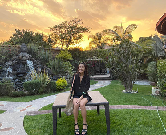 Aimee Leong sits in an elaborate garden
