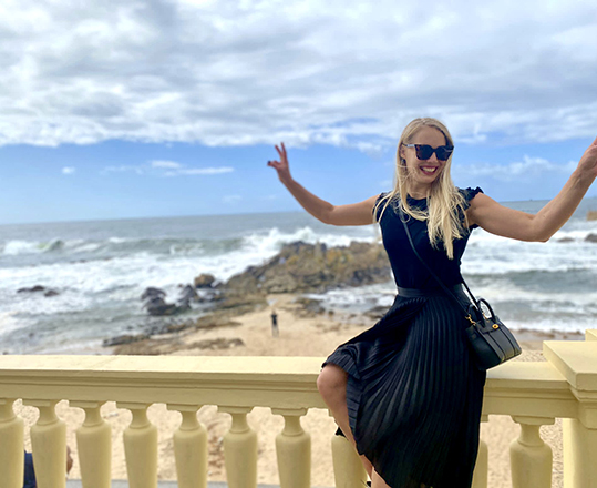 Karoliina Kettukari poses outdoors with the ocean in the background