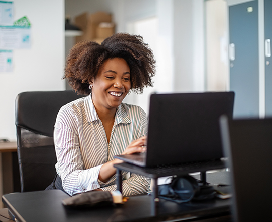 Woman happy working on laptop